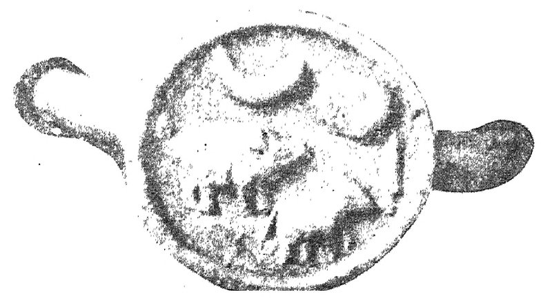 A round copper seal with the cut ends of its metal loop on either side, showing a crescent moon at the top and a faint animal in relief below.