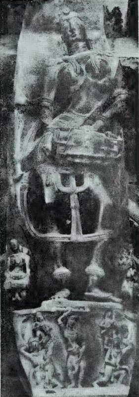 A bracket sculpture carved on a pillar, with small statues on each side and a panel of carved scenes below.