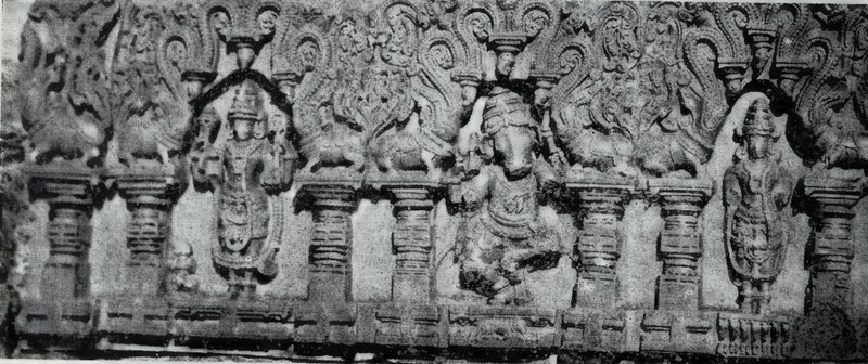 A long carved panel with statues standing in niches between short pillars, under scrolled arches.
